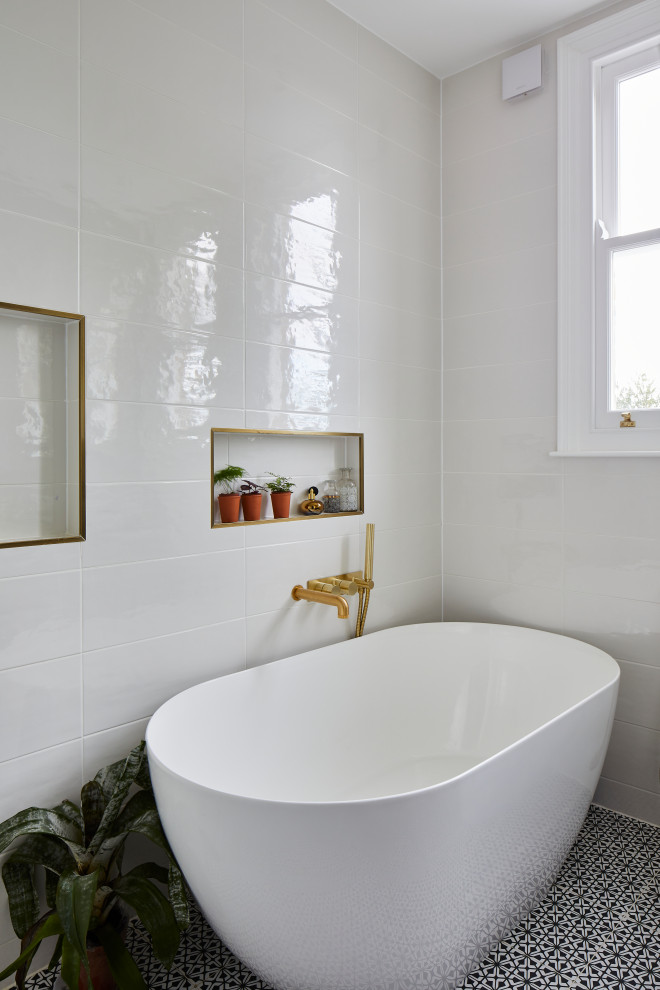 Photo of a small transitional bathroom in London with a wall-mount toilet, white tile, white walls, a vessel sink, terrazzo benchtops, multi-coloured floor, grey benchtops and a floating vanity.