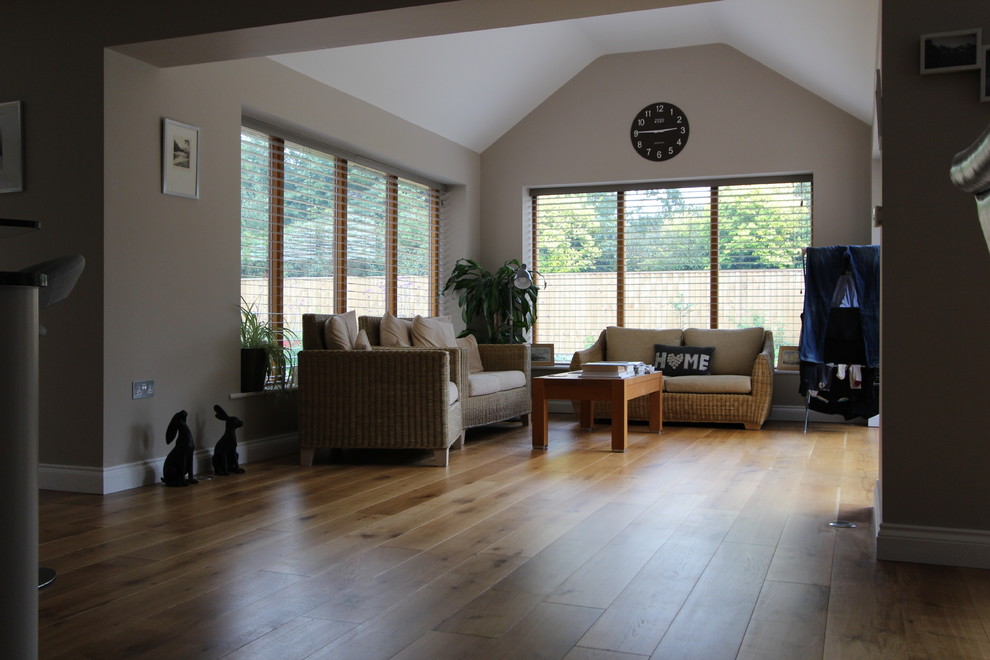 Photo of a large traditional open concept living room in Cheshire with beige walls, medium hardwood floors and brown floor.
