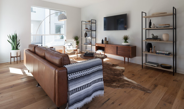 Scandinavian Modern Living Room With Leather Sofa And Cowhide Rug