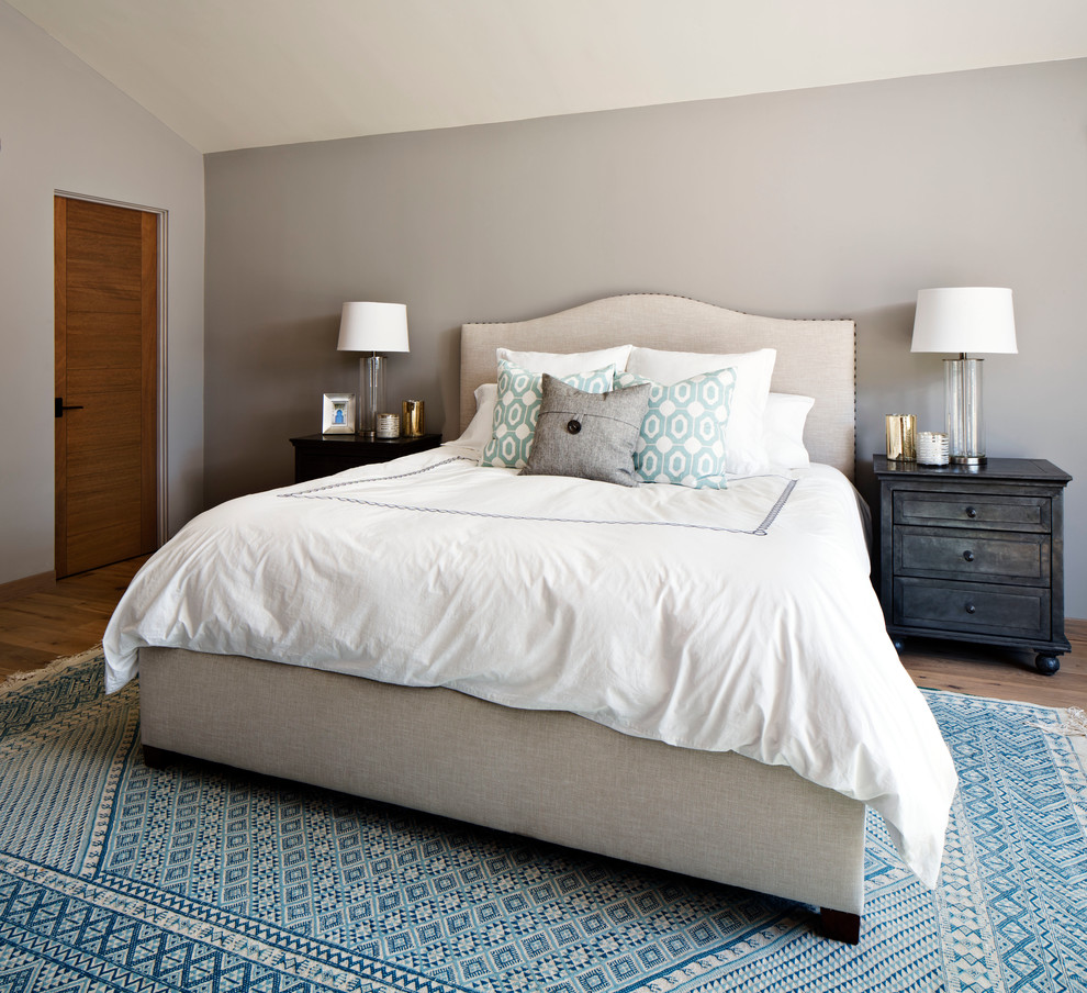 This is an example of a mid-sized contemporary master bedroom in San Diego with grey walls and light hardwood floors.