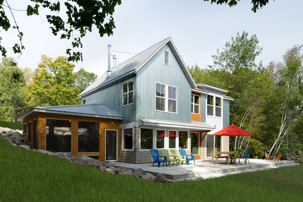 This is an example of a beach style two-storey exterior in Other with mixed siding.