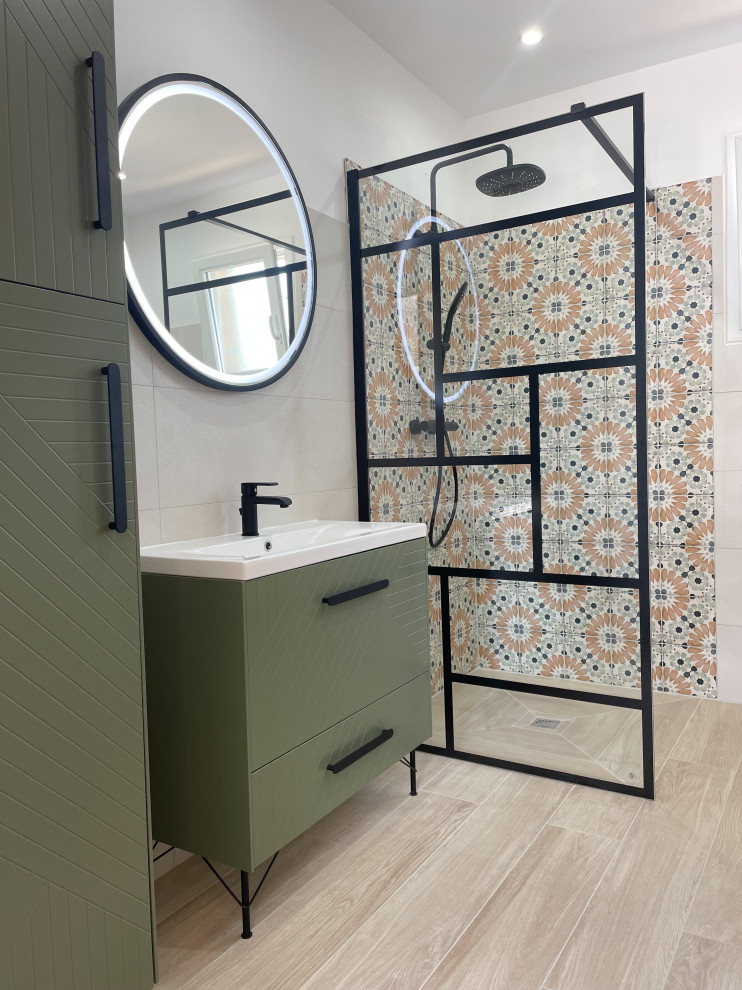 Small modern ensuite bathroom in Marseille with beaded cabinets, green cabinets, a built-in shower, a wall mounted toilet, beige tiles, cement tiles, beige walls, wood-effect flooring, a trough sink, tiled worktops, beige floors, beige worktops, a laundry area, a single sink and a freestanding vanity unit.