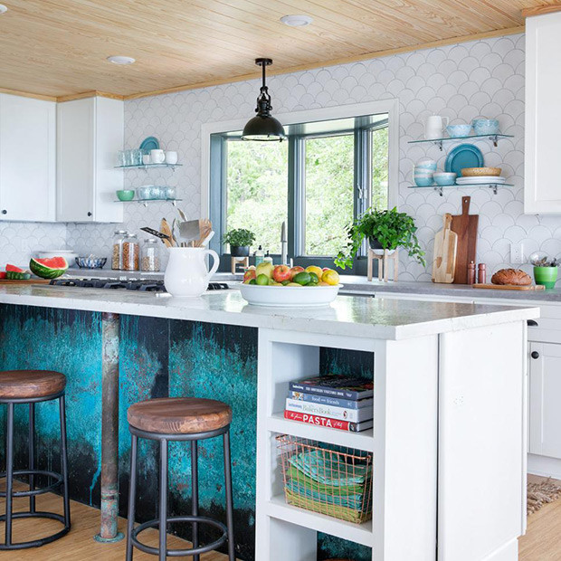 Inspiration for a large beach style l-shaped open plan kitchen in Other with a farmhouse sink, shaker cabinets, yellow cabinets, white splashback, ceramic splashback, stainless steel appliances, bamboo floors, multiple islands and tile benchtops.