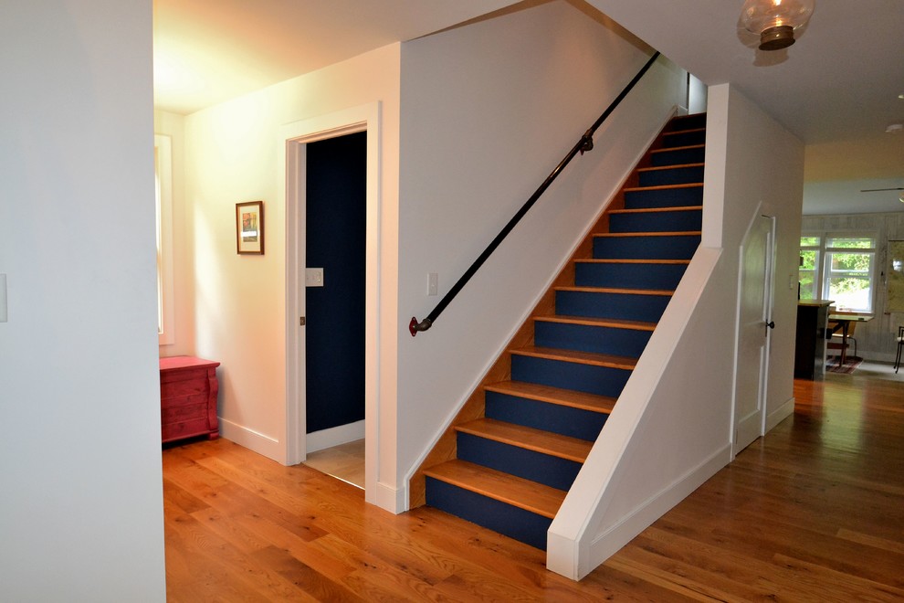 Design ideas for a mid-sized beach style wood straight staircase in Baltimore with painted wood risers.