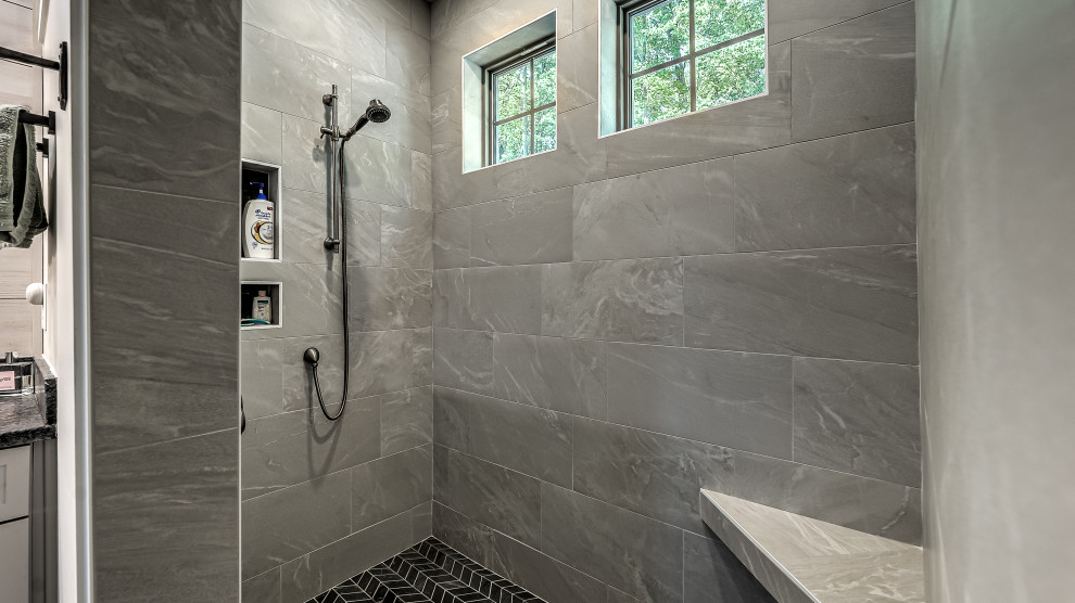 Inspiration for a medium sized traditional ensuite bathroom in Atlanta with beaded cabinets, black cabinets, a built in vanity unit, a walk-in shower, a two-piece toilet, porcelain tiles, grey walls, porcelain flooring, a built-in sink, granite worktops, grey floors, an open shower, black worktops, a shower bench and double sinks.
