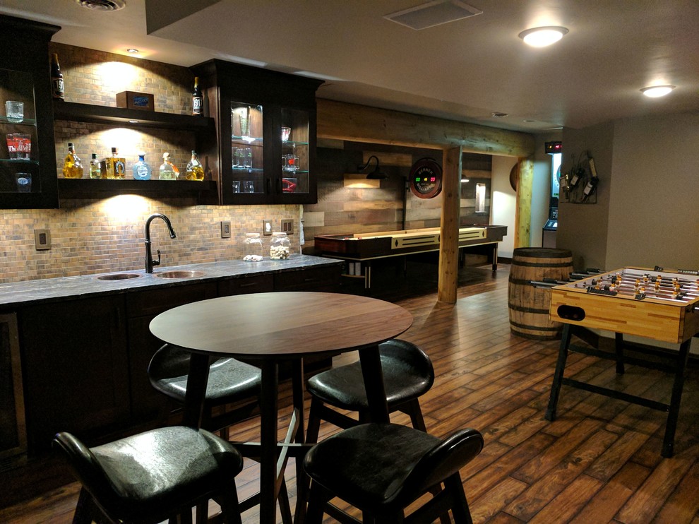 Basement - large rustic underground medium tone wood floor and brown floor basement idea with gray walls and no fireplace