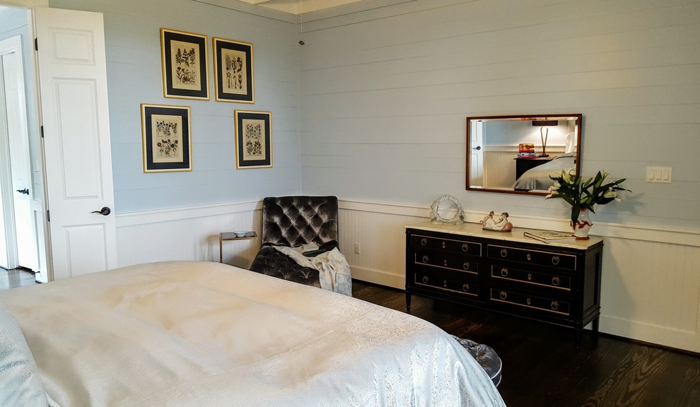 This is an example of a mid-sized transitional bedroom in Houston with blue walls and dark hardwood floors.