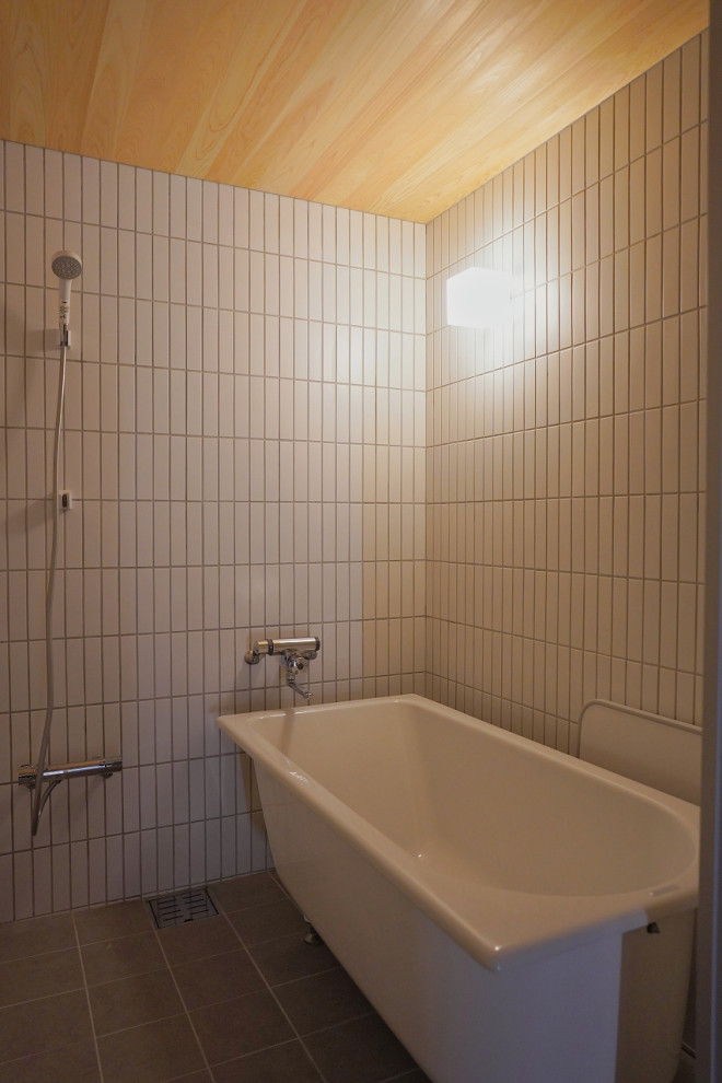 Idéer för mellanstora nordiska grått en-suite badrum, med öppna hyllor, grå skåp, ett fristående badkar, våtrum, en bidé, vit kakel, porslinskakel, grå väggar, mellanmörkt trägolv, ett integrerad handfat, bänkskiva i akrylsten, beiget golv och med dusch som är öppen