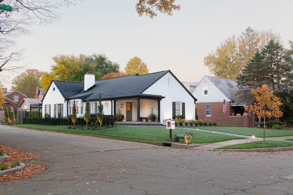 Traditional one-storey brick white house exterior in Indianapolis with a gable roof, a shingle roof and a black roof.