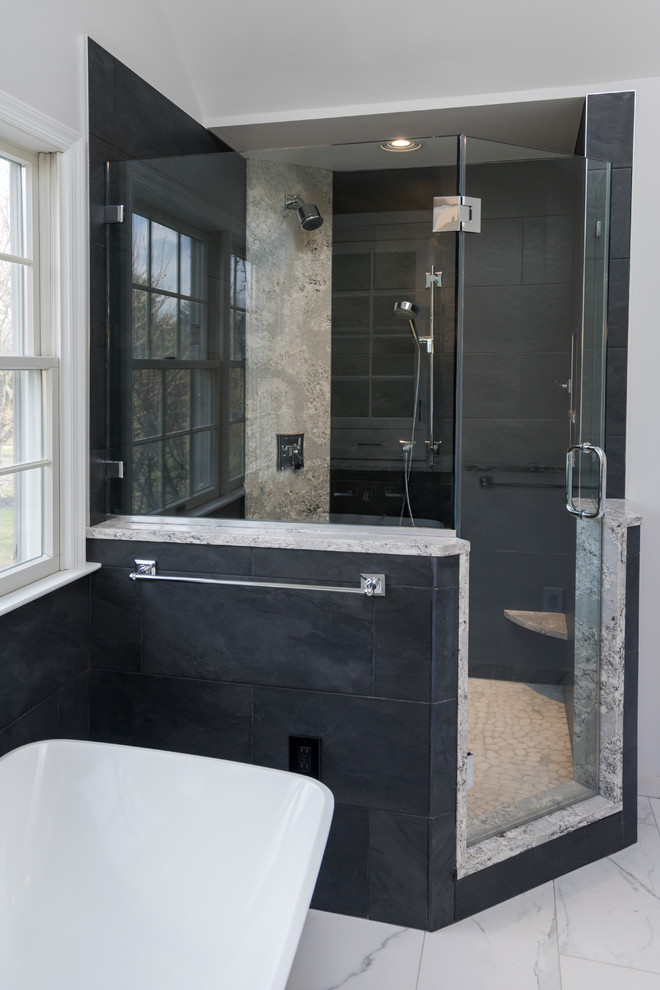 Design ideas for a mid-sized contemporary master bathroom in Philadelphia with shaker cabinets, white cabinets, a freestanding tub, an alcove shower, a two-piece toilet, black tile, glass sheet wall, grey walls, porcelain floors, an undermount sink, engineered quartz benchtops, white floor, a hinged shower door and multi-coloured benchtops.