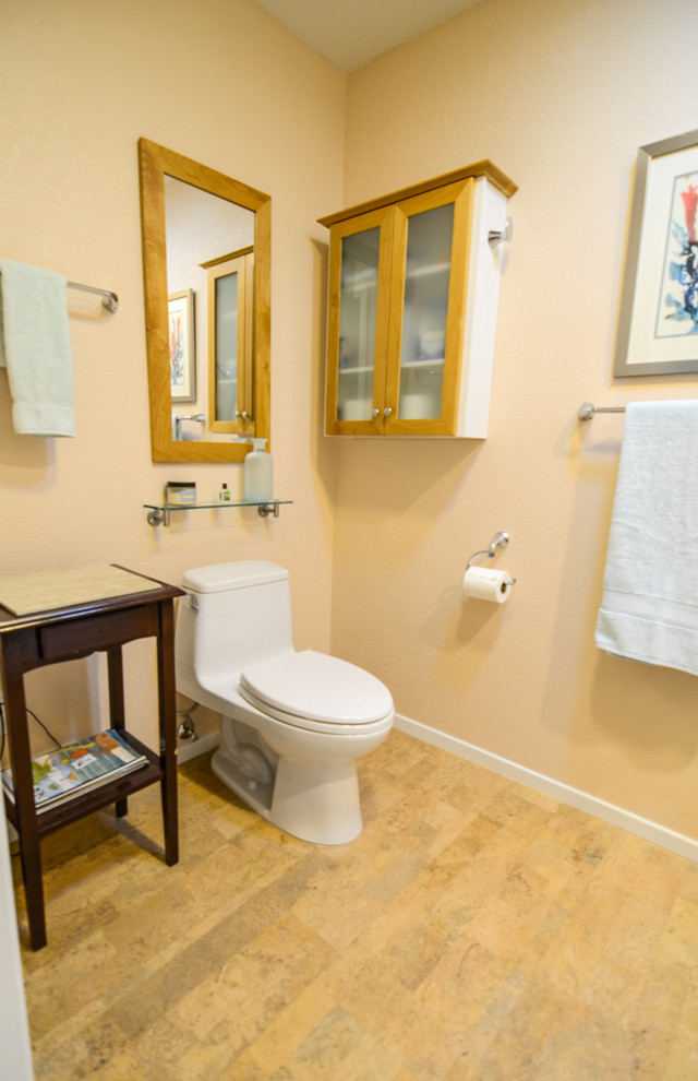 Mid-sized traditional 3/4 bathroom in Tampa with a vessel sink, flat-panel cabinets, dark wood cabinets, granite benchtops, an alcove shower, a one-piece toilet, beige tile, porcelain tile, beige walls and cork floors.