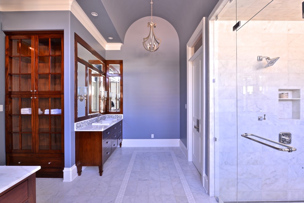 Design ideas for a large transitional bathroom in Dallas with a drop-in sink, flat-panel cabinets, dark wood cabinets, marble benchtops, a freestanding tub, a one-piece toilet, white tile, grey walls, marble floors and with a sauna.