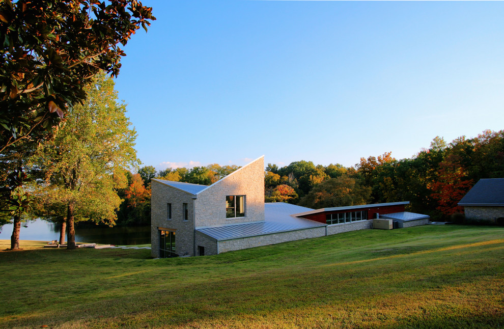 This is an example of a modern exterior in Nashville with stone veneer and a butterfly roof.
