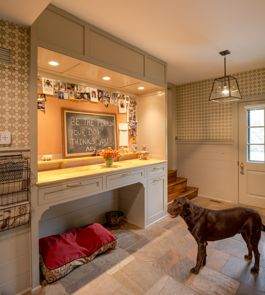 This is an example of a large traditional mudroom in Philadelphia with beige walls, travertine floors and a single front door.