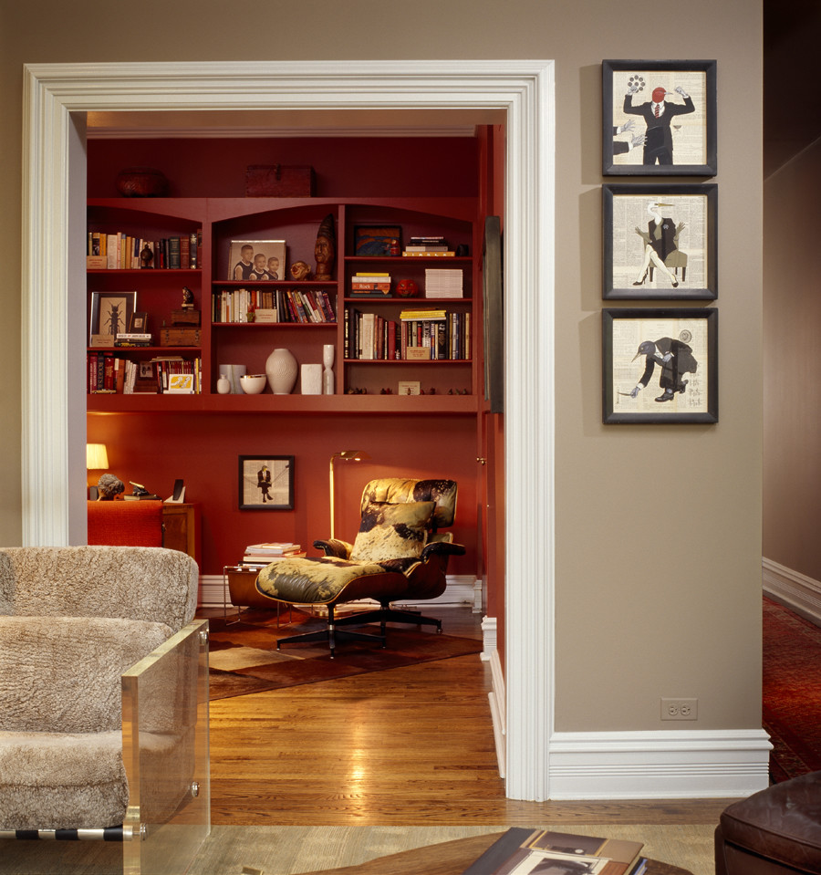 This is an example of a mid-sized contemporary study room in Chicago with red walls, light hardwood floors, a corner fireplace, a brick fireplace surround and a freestanding desk.