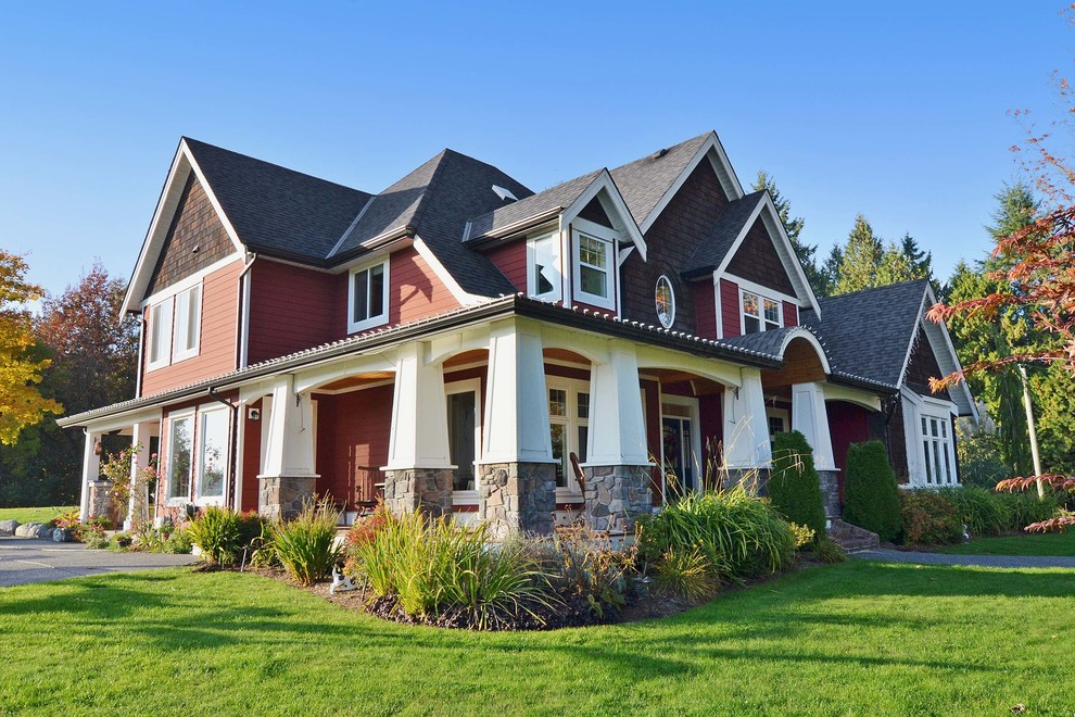 This is an example of a large arts and crafts three-storey red exterior in Vancouver with mixed siding and a gable roof.