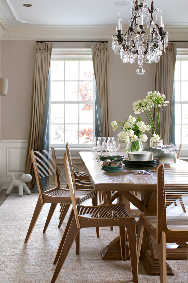 This is an example of a transitional dining room in Toronto with beige walls.