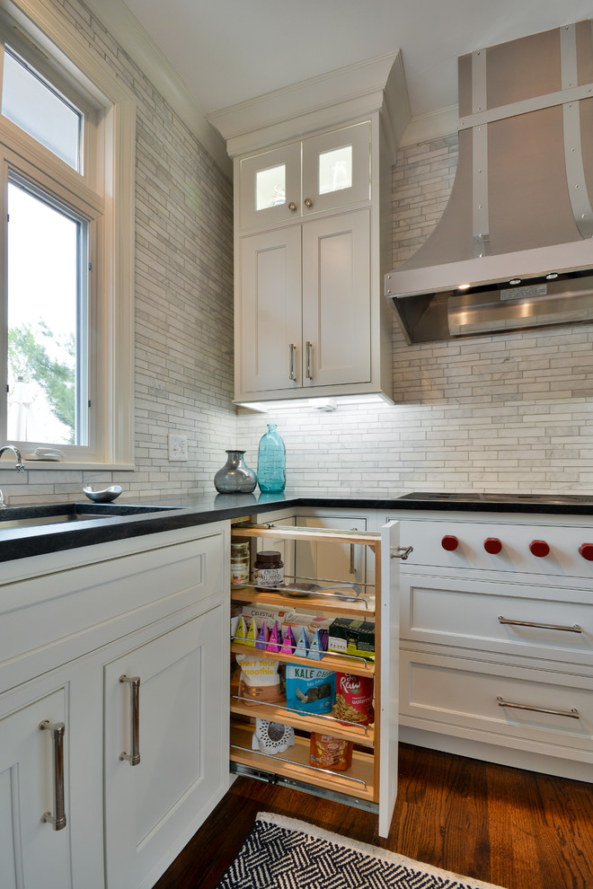 Example of a large transitional u-shaped dark wood floor and brown floor eat-in kitchen design in Chicago with an undermount sink, recessed-panel cabinets, white cabinets, soapstone countertops, gray backsplash, marble backsplash, stainless steel appliances and an island