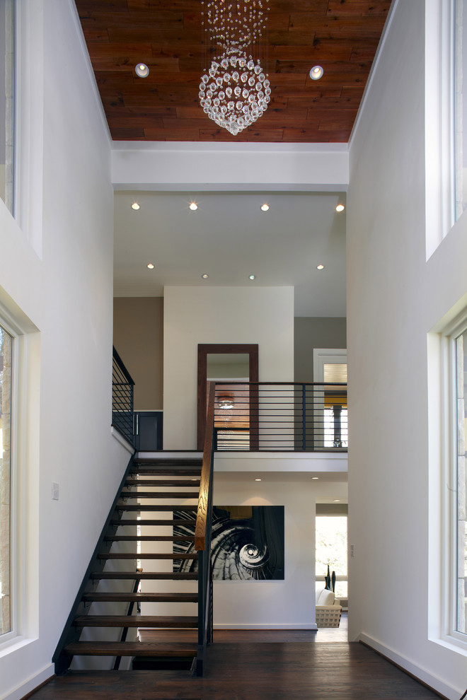 Contemporary wood floating staircase in Atlanta with open risers and metal railing.