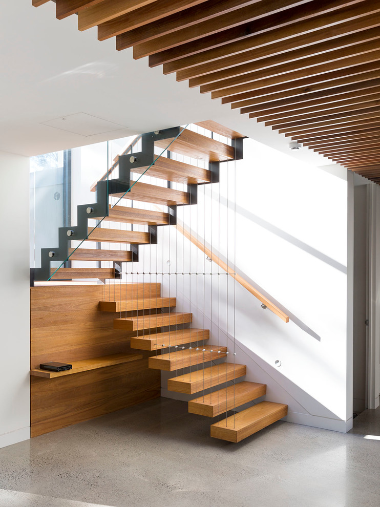 Design ideas for a large contemporary wood floating staircase in Melbourne with open risers.