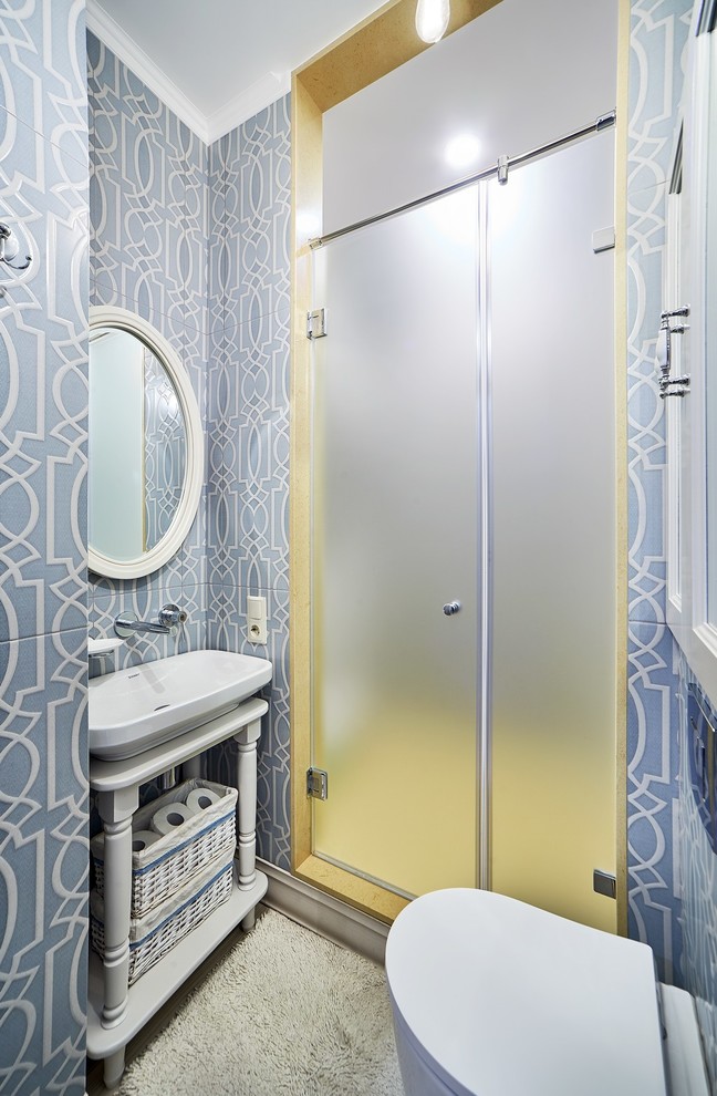 Design ideas for a transitional 3/4 bathroom in Other with open cabinets, an alcove shower, a wall-mount toilet, blue tile, white tile, a vessel sink and a hinged shower door.