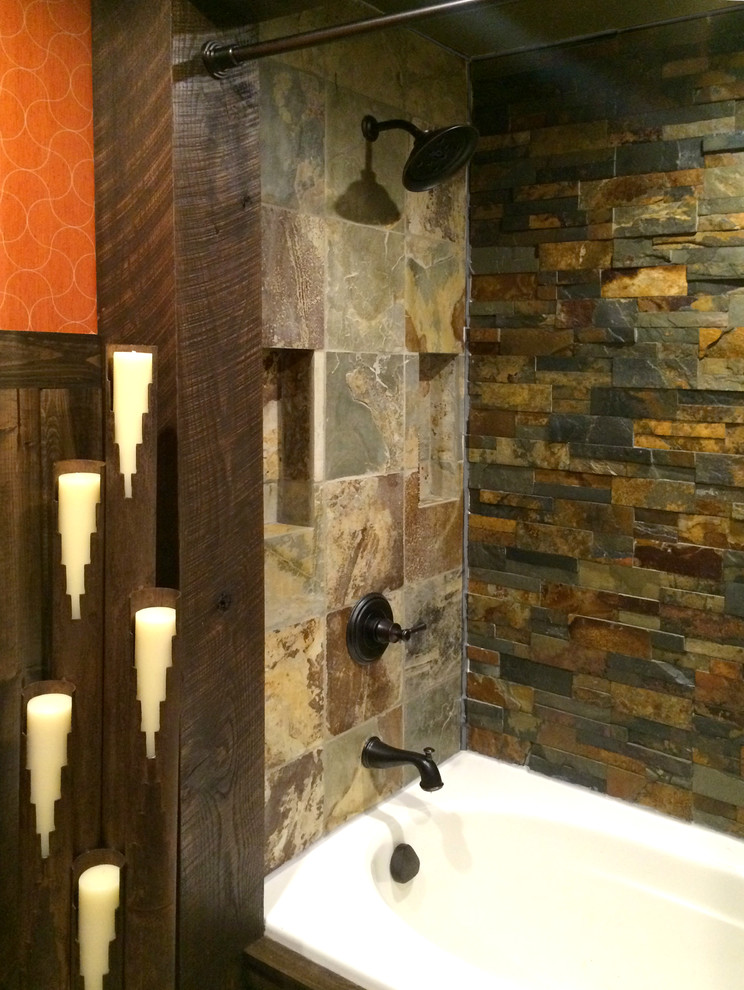 Mid-sized mountain style home design photo with a vessel sink, green cabinets, quartzite countertops, a two-piece toilet, orange walls and furniture-like cabinets