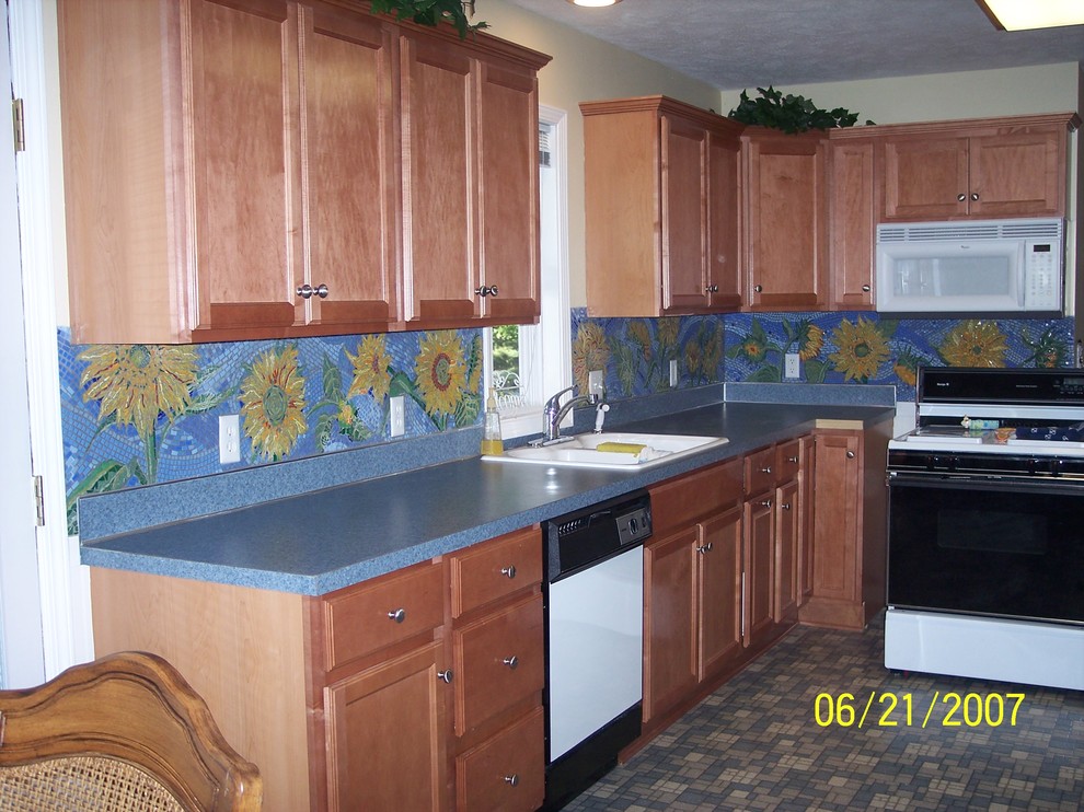 Design ideas for an eclectic kitchen in Grand Rapids with glass tile splashback.