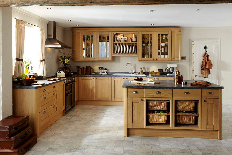 Design ideas for a mid-sized traditional l-shaped kitchen in Other with shaker cabinets, panelled appliances, limestone floors and with island.