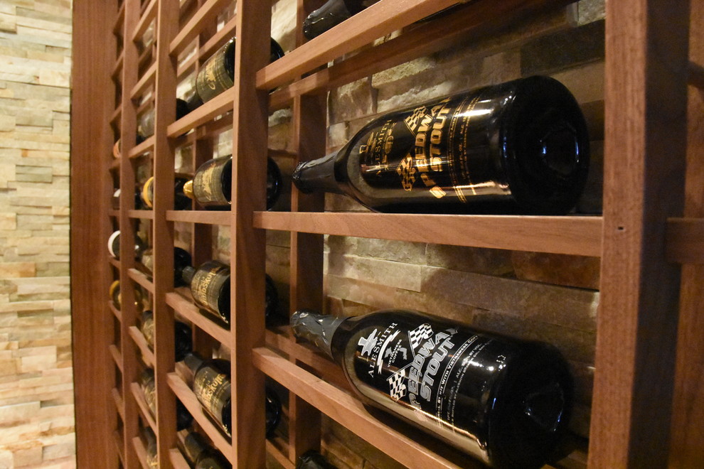 This is an example of a mid-sized traditional wine cellar in San Diego with marble floors and display racks.