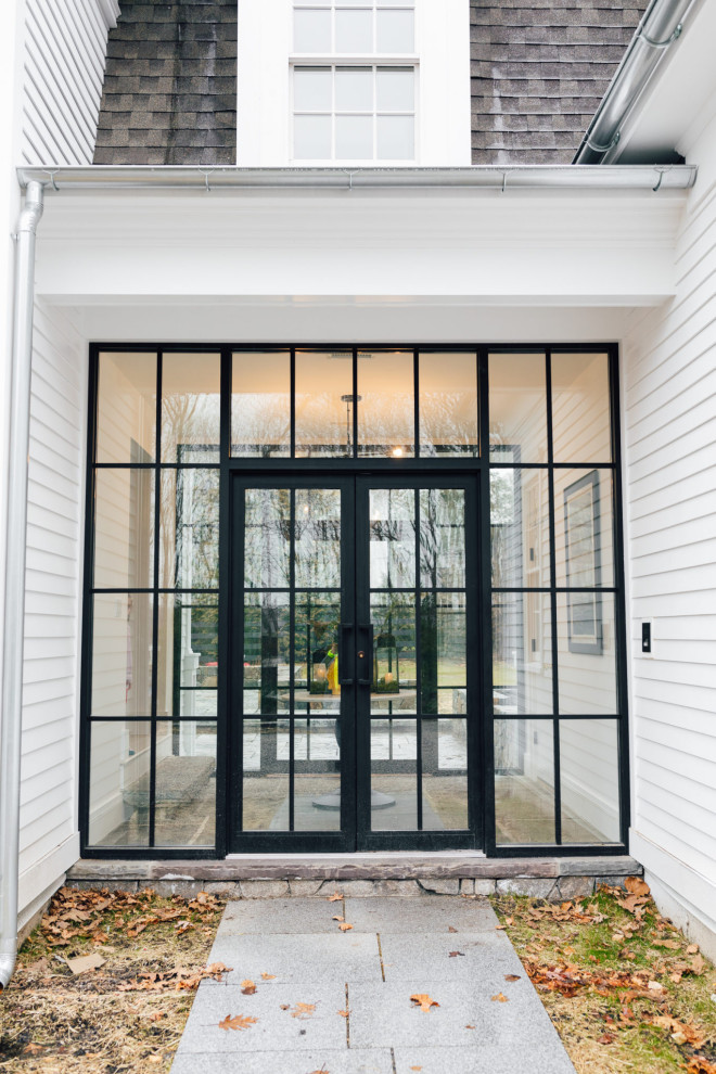Идея дизайна: вестибюль с бетонным полом, двустворчатой входной дверью и стеклянной входной дверью