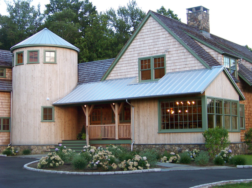 Inspiration for a country exterior in New York with stone veneer and a gable roof.