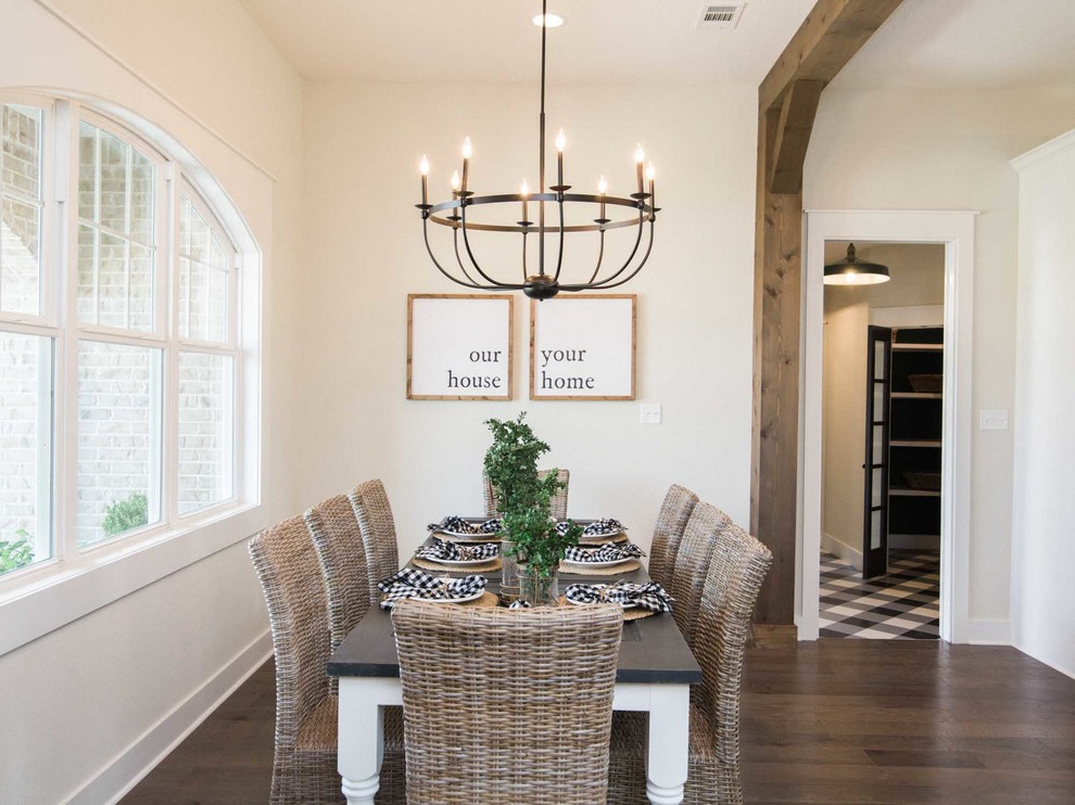 Photo of a mid-sized country open plan dining in Austin with white walls, laminate floors and brown floor.