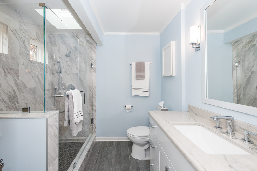 Inspiration for a mid-sized traditional master bathroom in DC Metro with flat-panel cabinets, white cabinets, a corner shower, a two-piece toilet, blue tile, marble, blue walls, slate floors, an undermount sink, granite benchtops, grey floor and a hinged shower door.