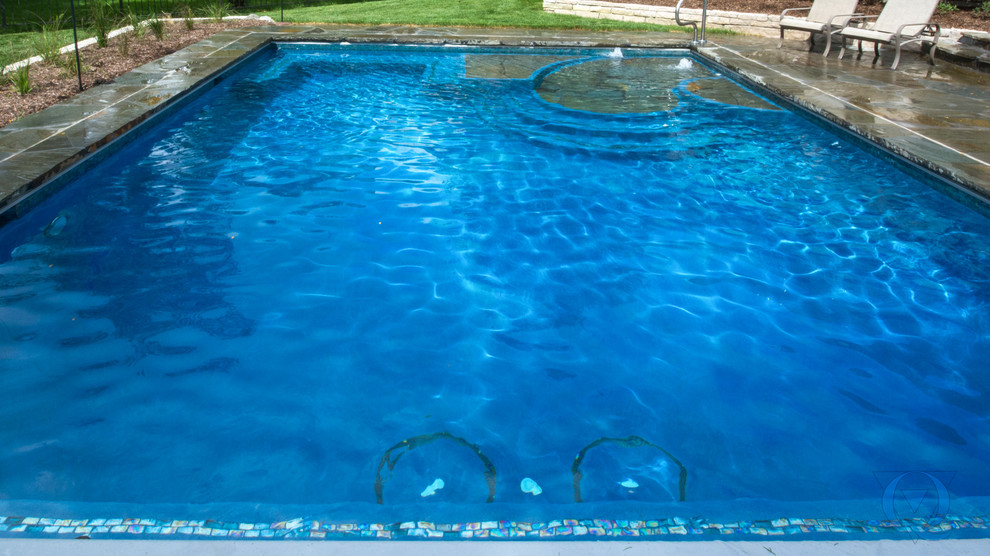 Pool fountain - mid-sized rustic backyard stone and rectangular lap pool fountain idea in Chicago