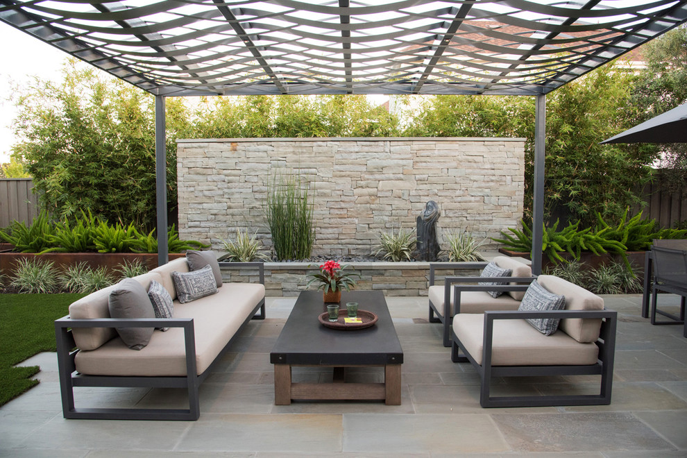 Mid-sized contemporary backyard patio in San Francisco with natural stone pavers and a pergola.