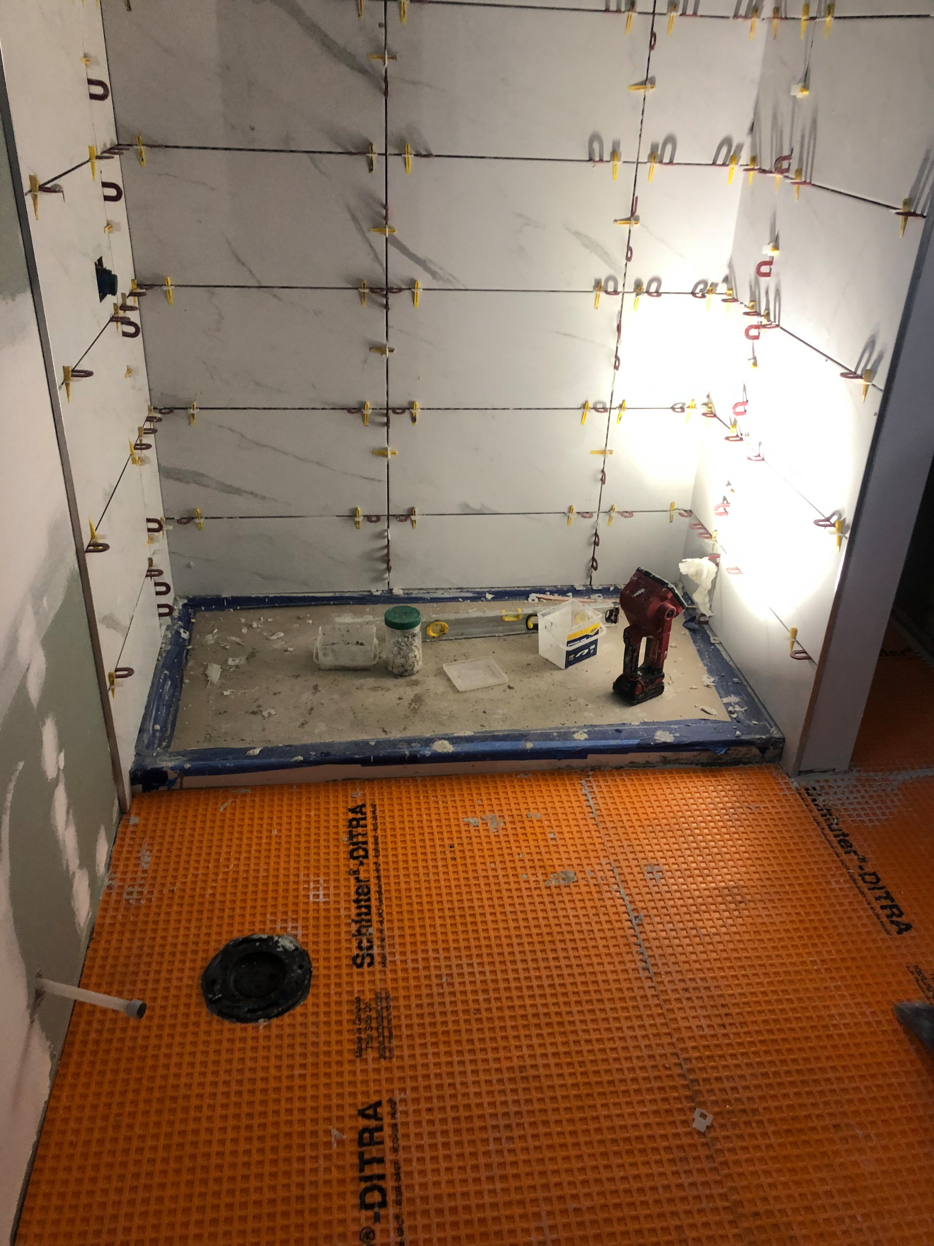 Tile install process including under tile waterproofing