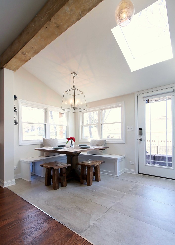 This is an example of a small transitional sunroom in Chicago with ceramic floors and a skylight.