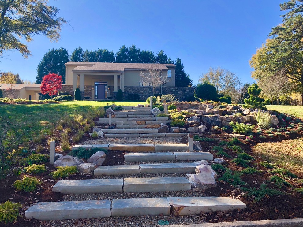 This is an example of a large asian front yard full sun garden in Charlotte with a garden path and natural stone pavers.