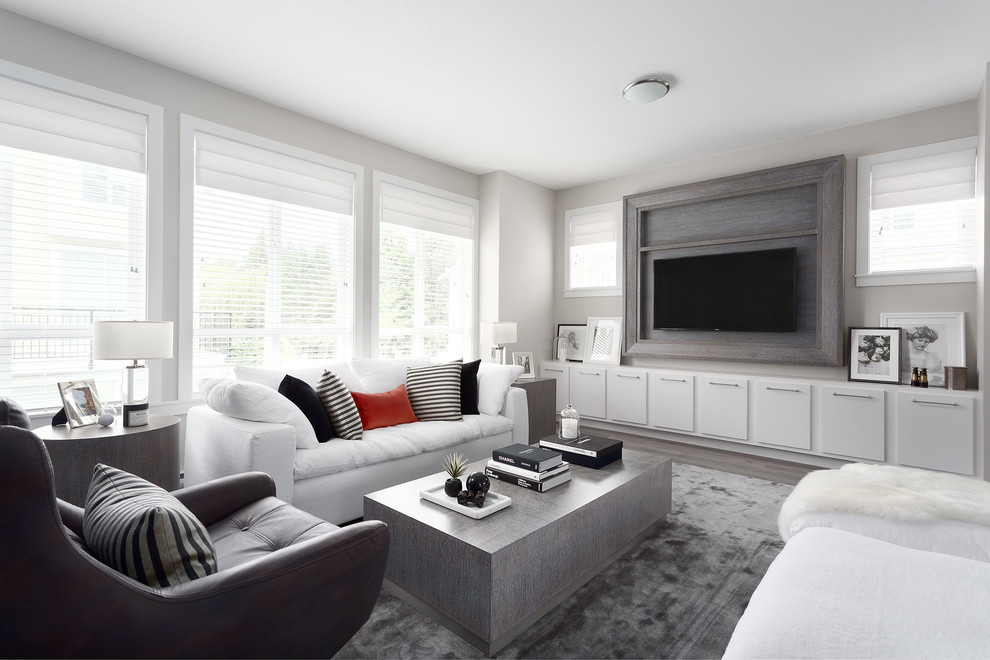 Inspiration for a transitional family room in Vancouver with grey walls, no fireplace, a wall-mounted tv and grey floor.
