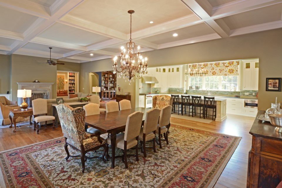 Design ideas for a mid-sized traditional open plan dining in Other with beige walls, light hardwood floors, a standard fireplace and a wood fireplace surround.