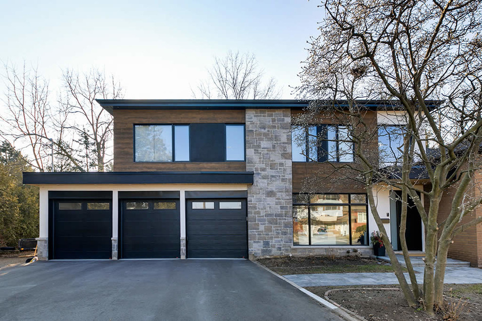 This is an example of a mid-sized contemporary two-storey exterior in Toronto.
