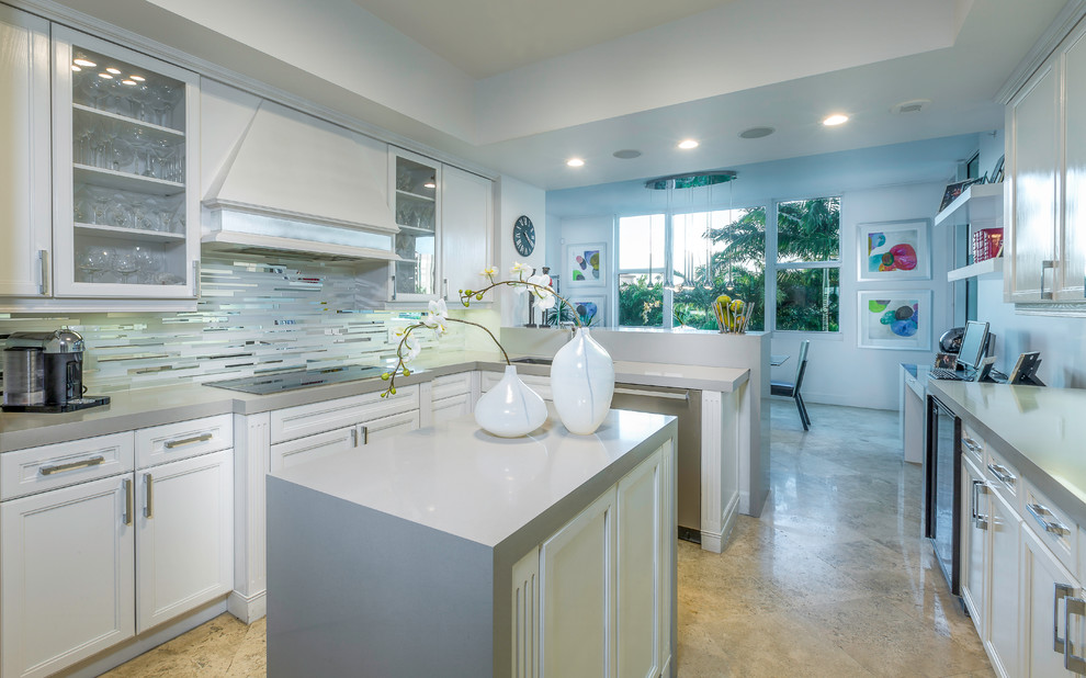 This is an example of a small modern u-shaped eat-in kitchen in Miami with an undermount sink, glass-front cabinets, white cabinets, quartz benchtops, grey splashback, matchstick tile splashback, stainless steel appliances, ceramic floors and with island.