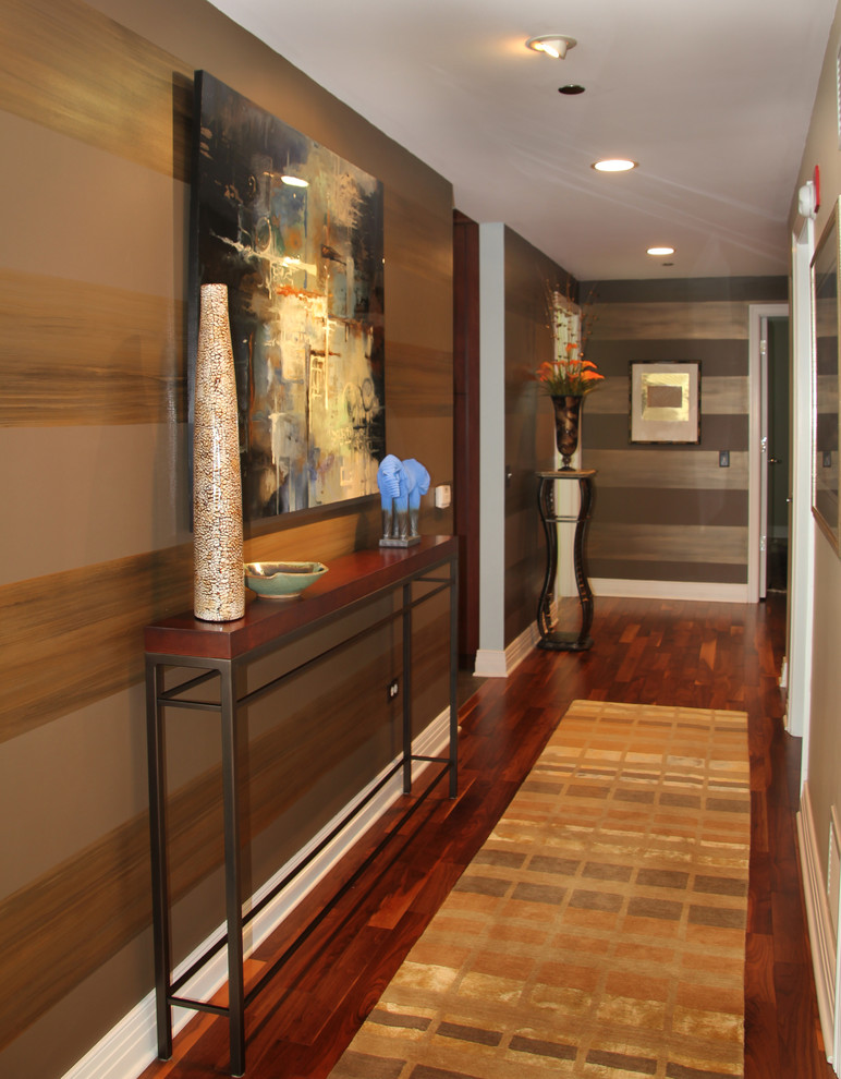 Inspiration for a mid-sized eclectic entryway in Chicago with brown walls, dark hardwood floors and brown floor.