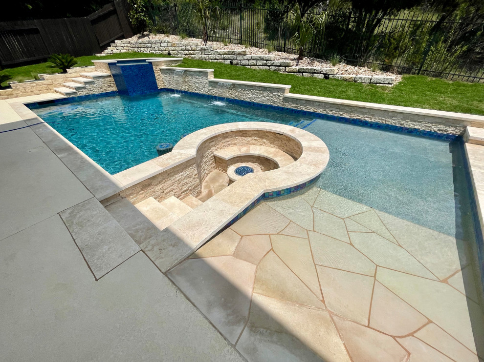 Large transitional backyard stone and rectangular pool fountain photo in Austin