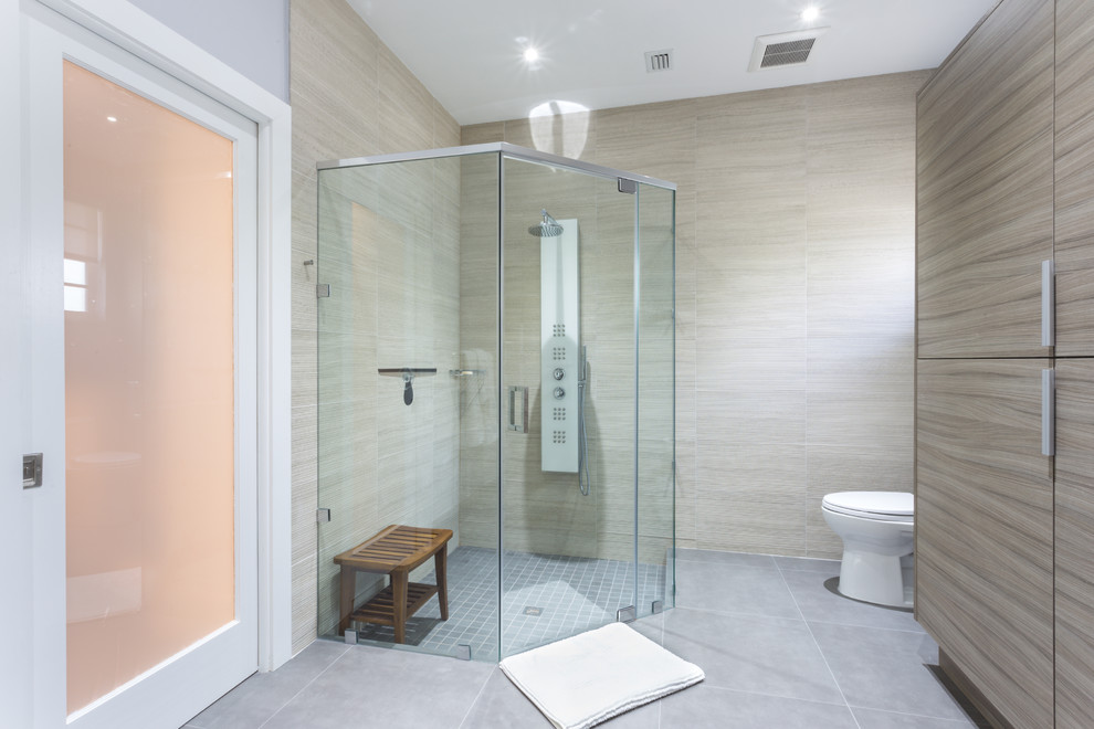 Photo of a large modern master bathroom in Miami with a vessel sink, flat-panel cabinets, grey cabinets, engineered quartz benchtops, a corner shower, a one-piece toilet, multi-coloured tile, porcelain tile, white walls and porcelain floors.