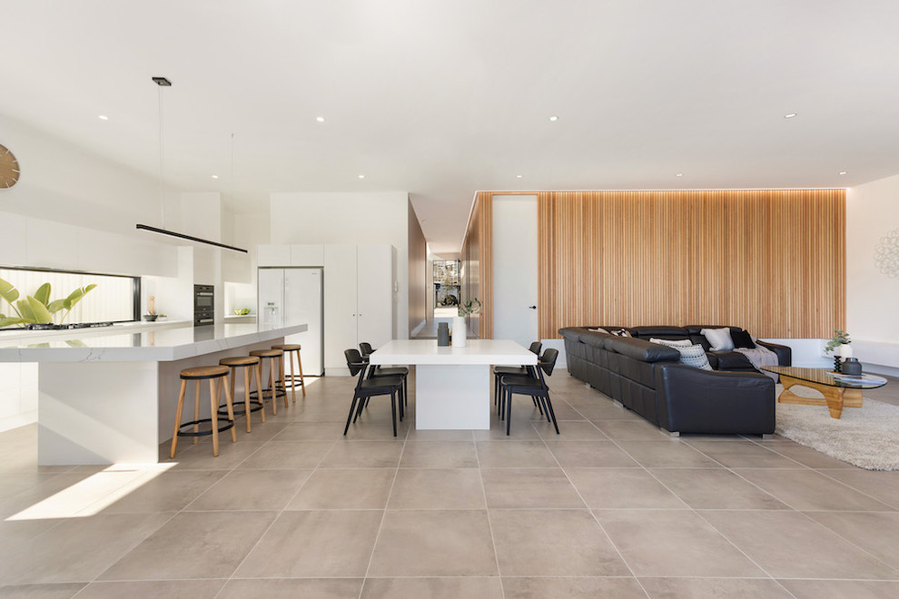 This is an example of a beach style living room in Sydney with ceramic floors.