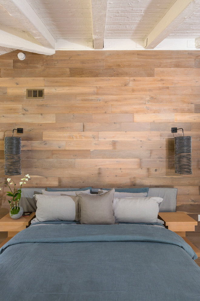 Inspiration for a beach style bedroom in Los Angeles with brown walls.