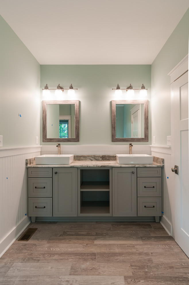 Inspiration for a small contemporary master bathroom in Richmond with raised-panel cabinets, grey cabinets, a drop-in tub, an alcove shower, a two-piece toilet, green walls, ceramic floors, an integrated sink, granite benchtops, brown floor and a sliding shower screen.