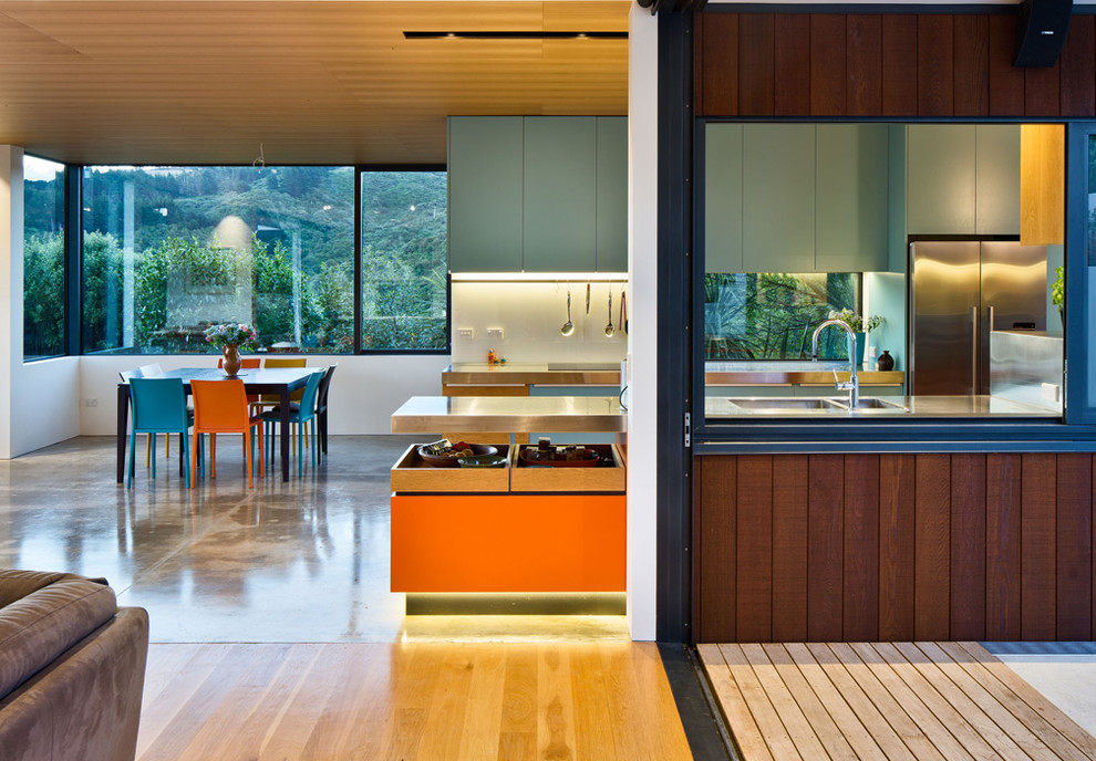 Photo of a large contemporary single-wall kitchen pantry in Wellington with stainless steel benchtops and with island.