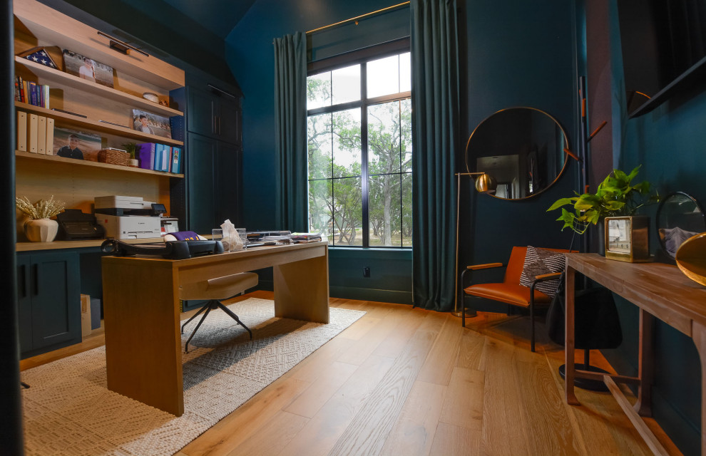 Lantlig inredning av ett arbetsrum, med blå väggar och ljust trägolv